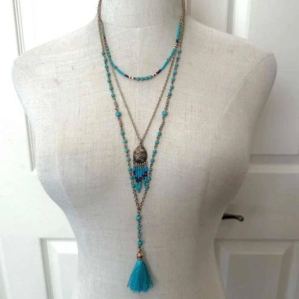 Gold tone and blue triple chain tassel necklace